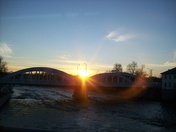The Afternoon sun from behind Front St. bridge 