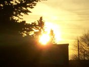 Evening sun appearing from behind a Building