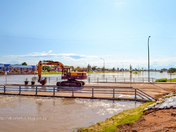 Excavator on a flooded bridge