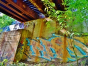 Graffiti bellow a railroad bridge.