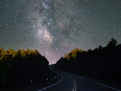 Winding road under starry skies