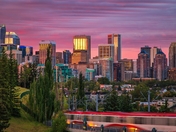 Calgary City Train Travelling Under A Sunrise Sky 