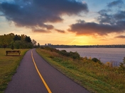 A Lakeside Pathway At Sunrise
