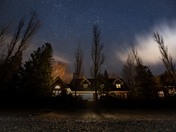 House at night with sky full of stars