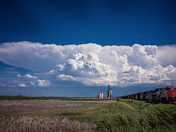 Train Leaving Grain Terminal with approaching Storm