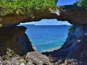 Bear’s rump and Flowerpot islands seen thru the opening below a natural bridge.
