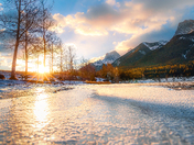 Sunrise Glow Over A Frozen Canmore Lake