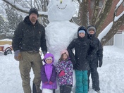 Garrick and his four girls from left to right, Cliodhna, Saoirse, Tegan, and Camilla with their giant 7 ft tall snowman named Hernando in Arlington, MA.