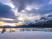 Sunrise Cloudscape Over Snowy Mountains And Lake