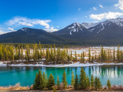 Sunlit Mountains And River In Banff
