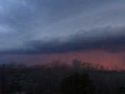 Sun setting behind approaching storm