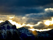 An angry sky over snowcapped mountains