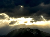 An angry sky over snowcapped mountains