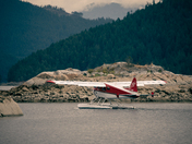 Dehavilland Beaver float plane going through a cut in an an island before take-off
