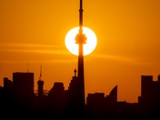 Sunrise aligns with the Toronto CN tower