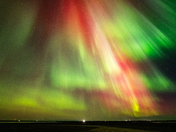 Northern Lights and town lights in the distance