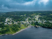 Corner Brook from above — where lush green hills meet the calm waters of the Bay of Islands
