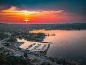 Where the marina sleeps under a burning sky 