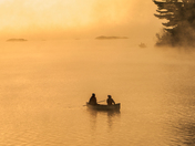 Canoeists on a Foggy Lake