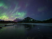 Aurora Over a Frozen Mountain Lake