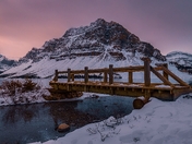 Sunrise Over Mountains And Footbridge At Bow Lake