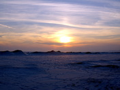 Sunset on frozen beach