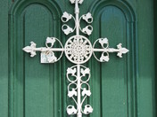 OLD METAL CROSS ON WOOD DOOR