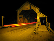 Irish Hardscrabble / Covered bridge at night with traffic